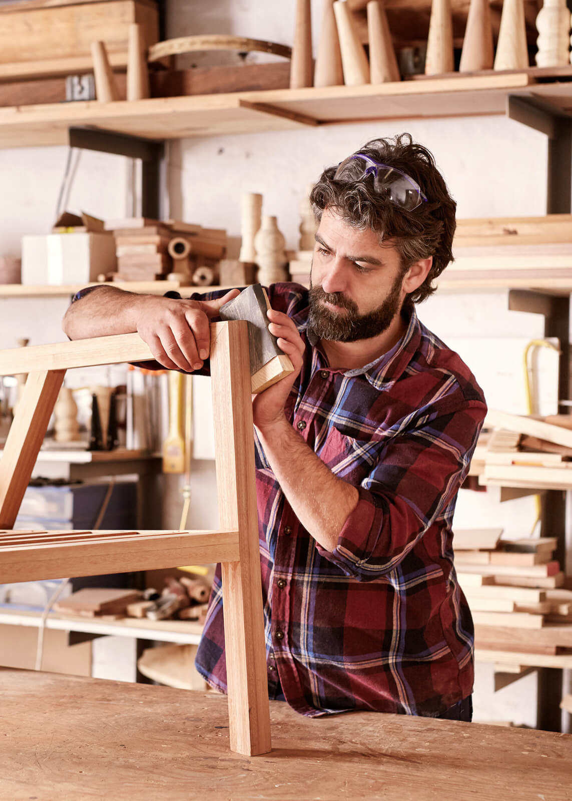 Growth man-sanding-a-wooden-chair